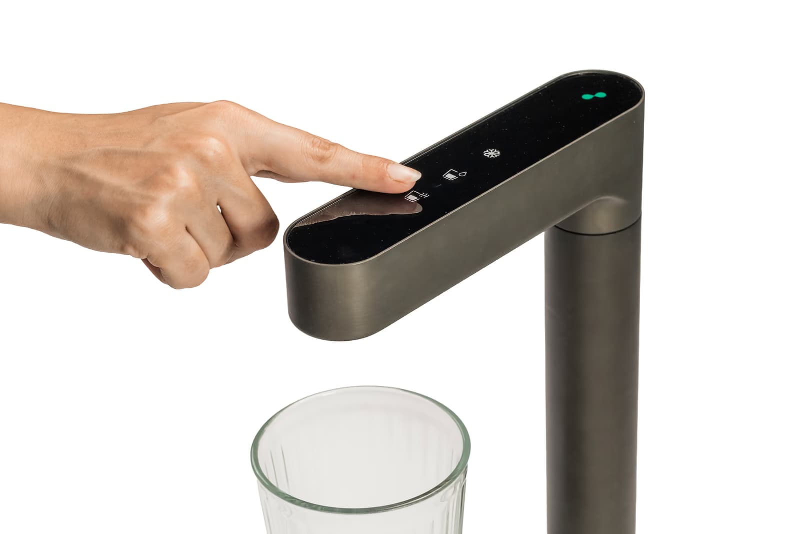 A finger pressing a touch button on the Boon Purify Tap Pro P2 to fill a glass