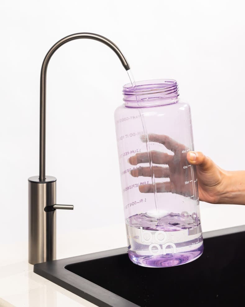 Boon purifier tap filling a water bottle with purified water