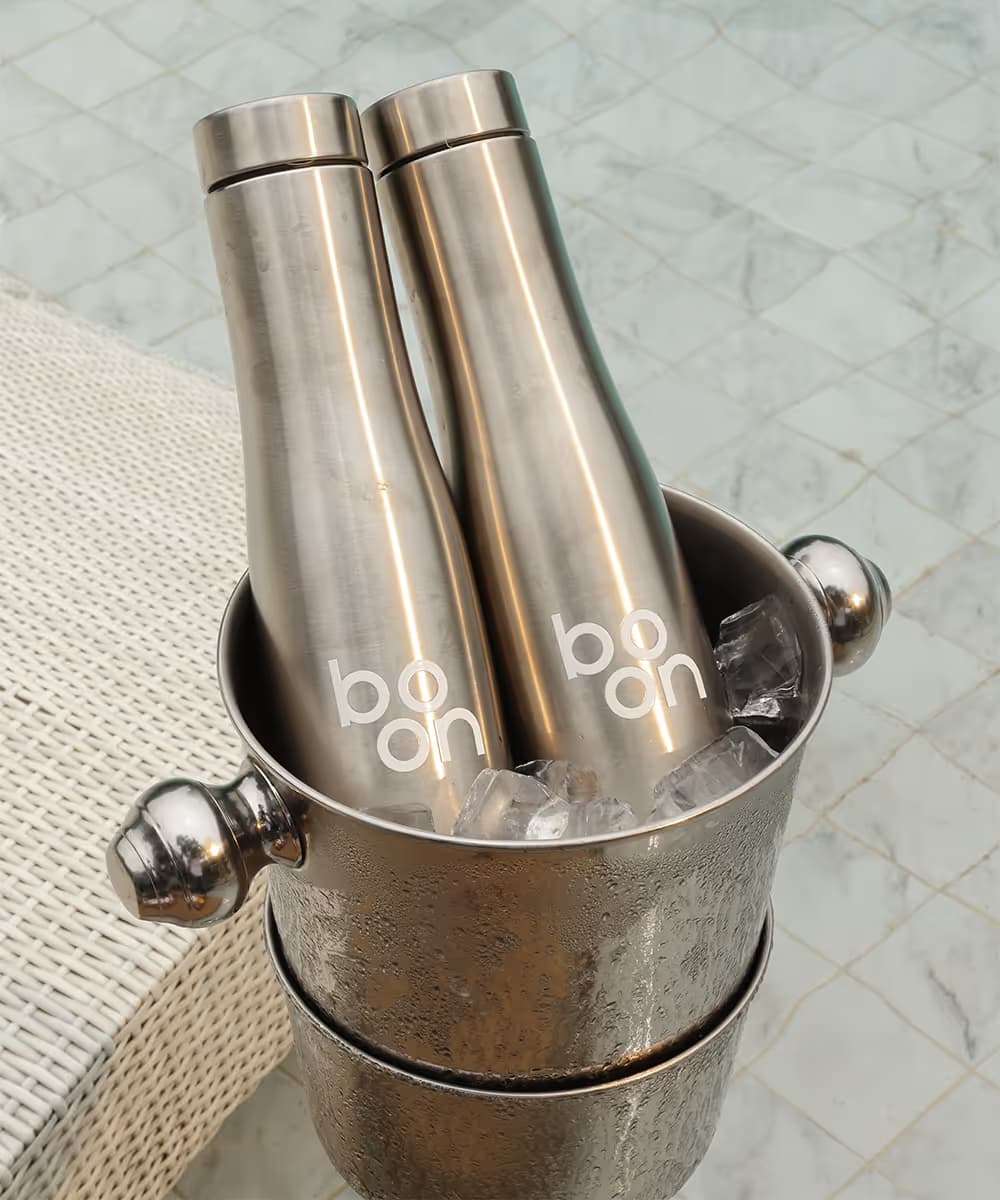 Boon glass bottles chilling in an ice bucket