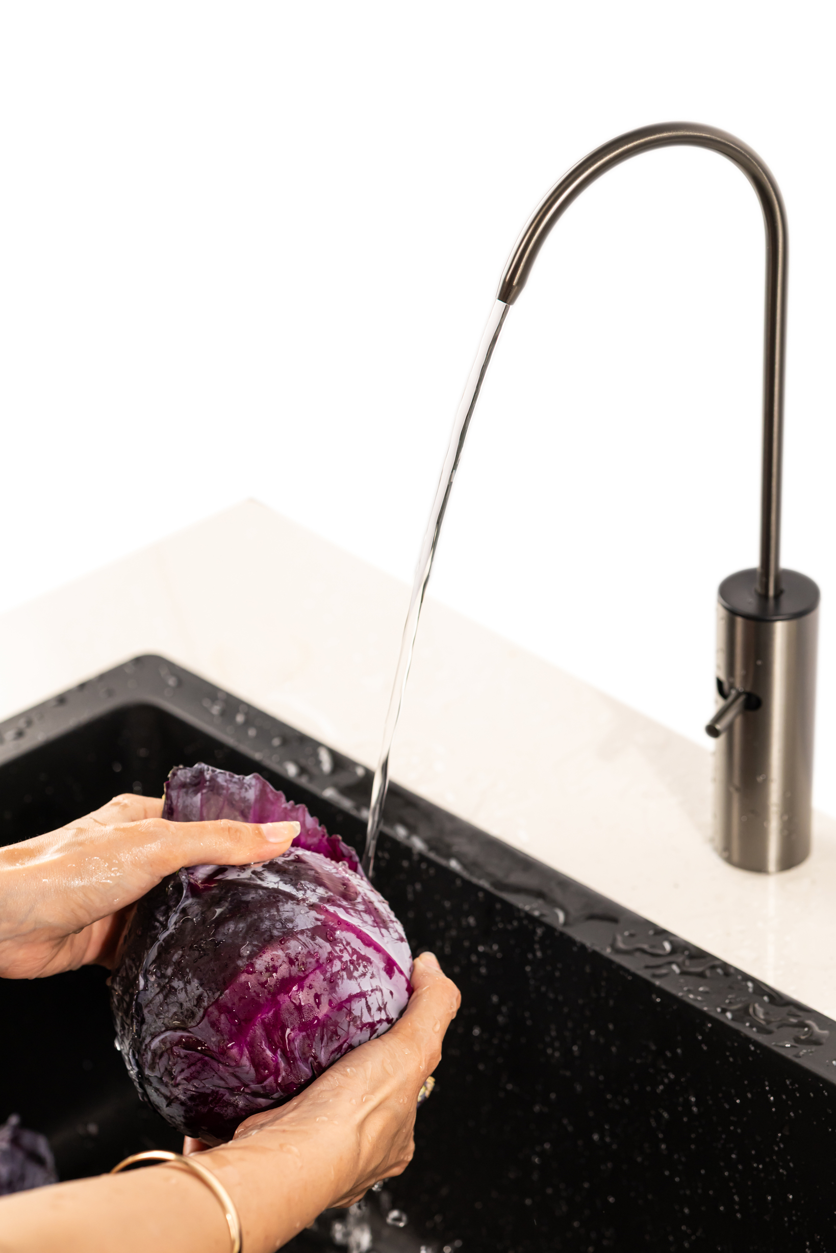Running clean water over vegetables with Boon Tap