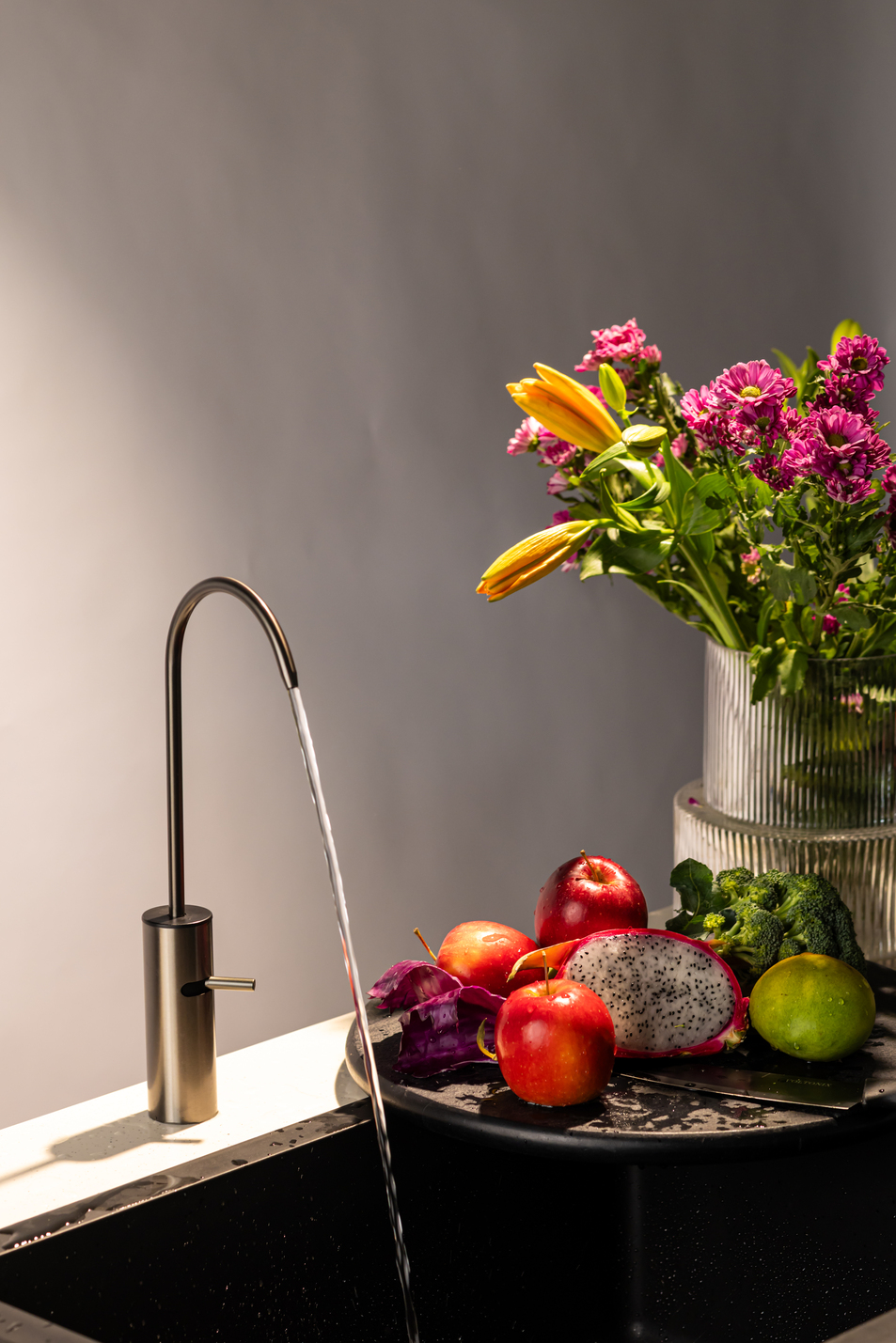 Boon Tap on a counter beside a flower, soft morning light.