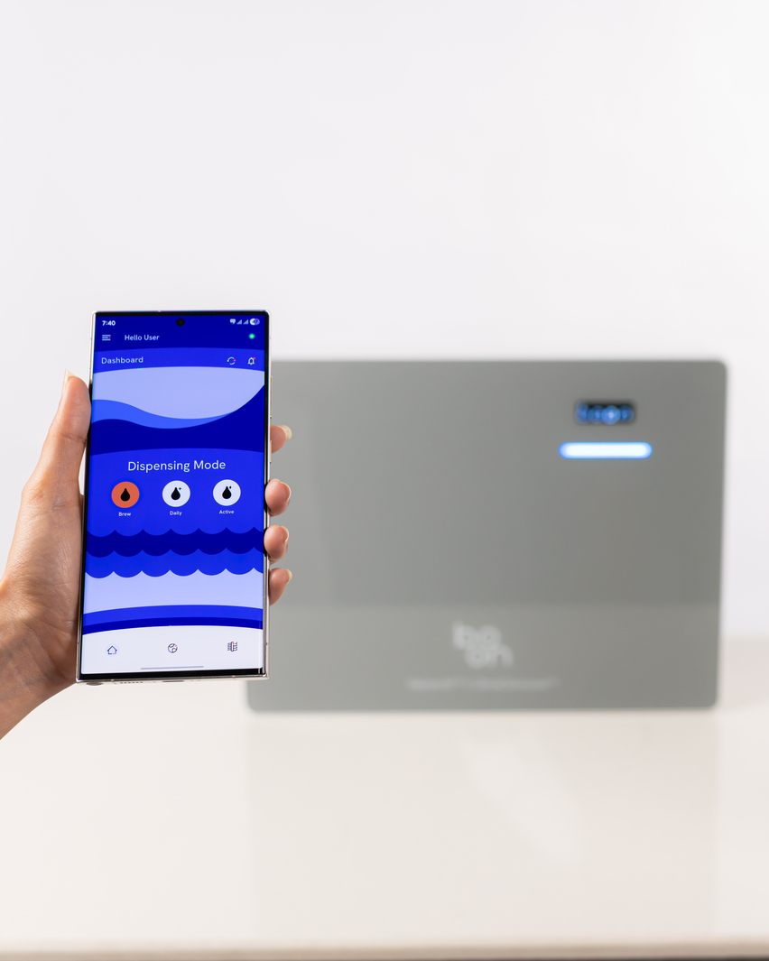 Hand holding phone showing WaterAI dashboard.